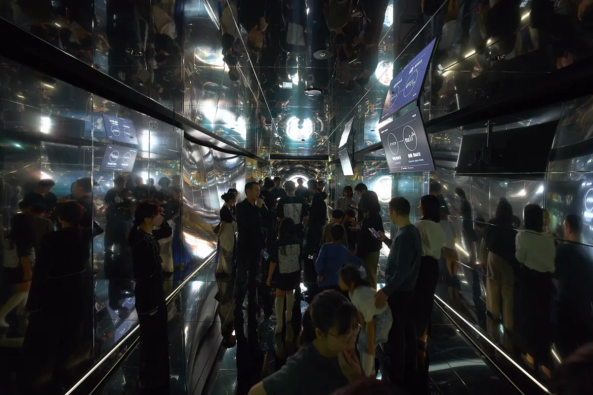 Visitors gathered in the mirrored antechamber