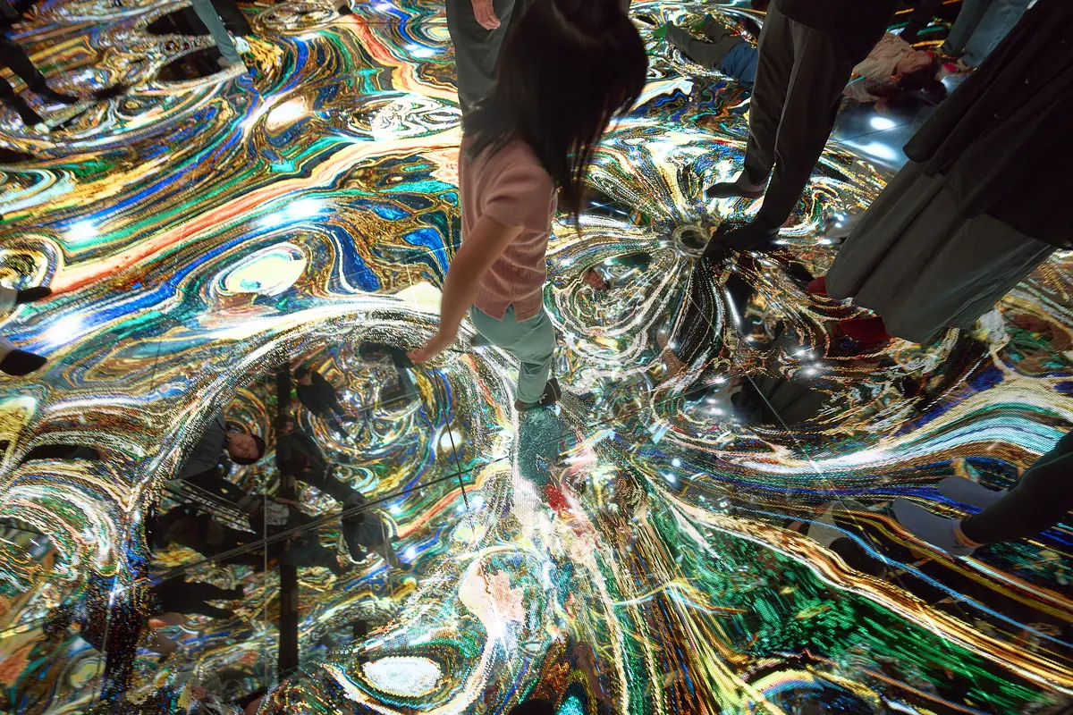 A child walking on a floor of flowing light